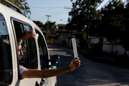 A member of staff at the World Mosquito Program releases Wolbachia mosquitoes in Niterói. The car contains 900 tubes that he will release every 50 metres.