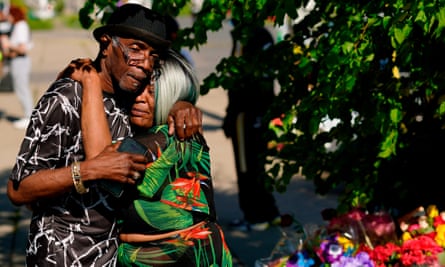 People hug outside a supermarket in Buffalo, New York, after a mass shooting in May 2022.