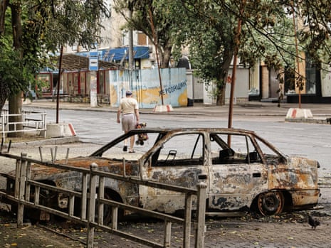 A burned out car on a street