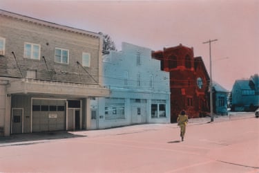 a person in street running toward buildings