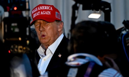 Donald Trump in a red Make America Great Again baseball cap
