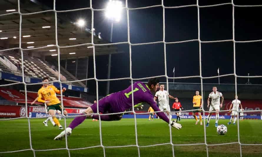 Harry Wilson of Wales scores past Thibaut Courtois.