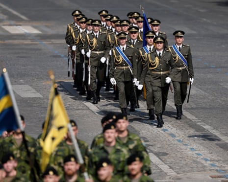 A contingent of Ukrainian soldiers march during the annual Bastille Day military parade on the Champs-Elysees avenue in Paris, France.