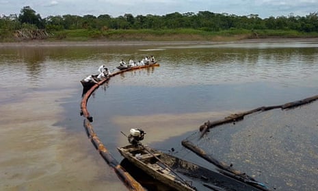 Workers attempting to stop the flow of  oil in the Cuninico River in September 2022 following the spill