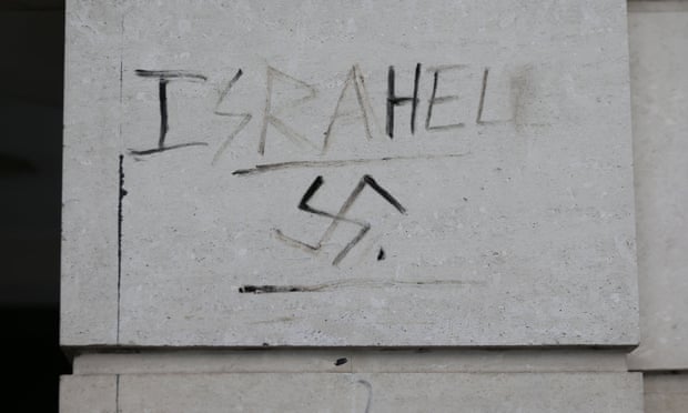 Graffiti next to a swastika on a wall in Victoria, London. 
