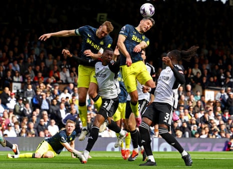 Newcastle United's Fabian Schar and Dan Burn go up for a header with Fulham's Tosin Adarabioyo.
