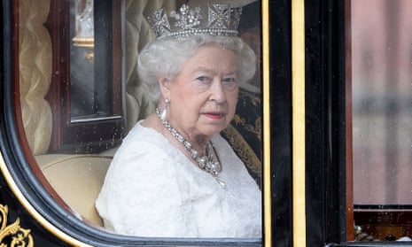 Queen Elizabeth II travels towards the Houses of Parliament in the Jubilee State Carriage as she prepares to attend the State Opening of Parliament in central London. 