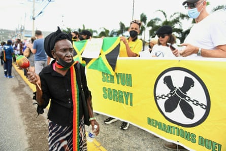 People calling for slavery reparations protest outside the entrance of the British high commission during the visit of the Duke and Duchess of Cambridge to Kingston, Jamaica, in March 2022.