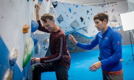 Honnold helps Sam Wollaston with his bouldering.