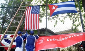 Cuban players hang up a banner before a clinic held for Cuban children by members of the Tampa Bay Rays.