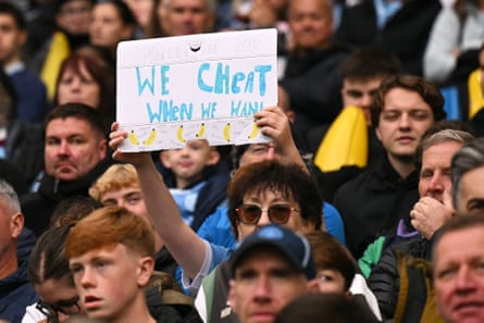 A Manchester City fan holds up a banner during the club's Premier League match with Ipswich at the Etihad Stadium.