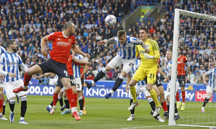 Danny Ward of Huddersfield Town heads clear.