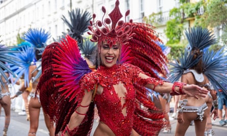 A samba dancer poses for a photo during the parade of the Notting Hill carnival in London, on 28 August.