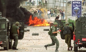 Israeli soldiers and Palestinian youths clash in Ramallah after Ariel Sharon’s visit to al-Aqsa compound, 28 September 2000.