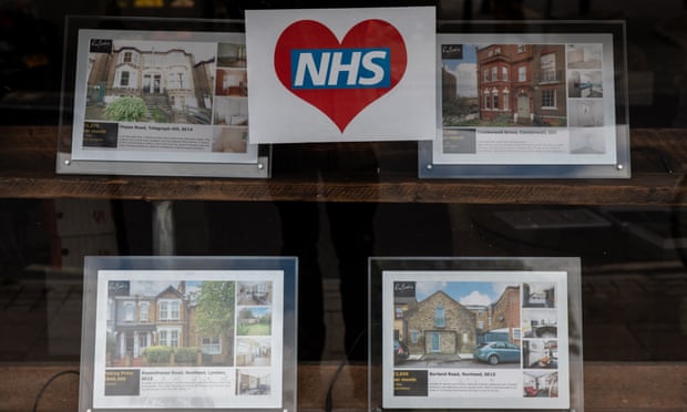 London estate agent's window with NHS poster