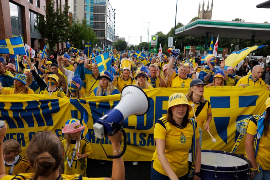 Sweden fans sing and march to Bramall Lane stadium.