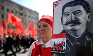 A Communist party activist with a banner of Joseph Stalin at a May Day rally in Moscow.