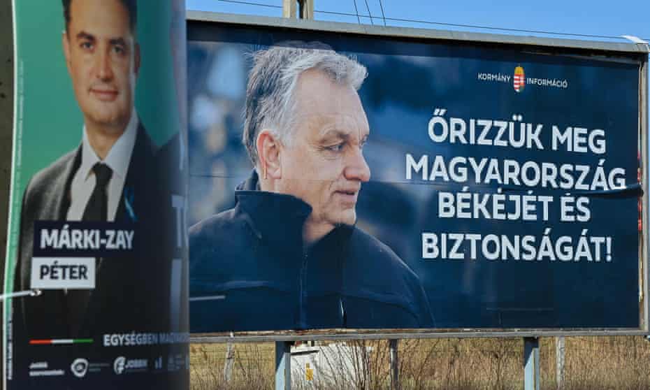 An election poster of the Hungarian prime minister Viktor Orbán (right), next to one for opposition leader Péter Márki-Zay. Orban's message translates as 'Let's save Hungary's peace and safety!'