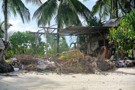 Remnants of storm damage is seen outside the home of Katoatau’s parents in Kiribati
