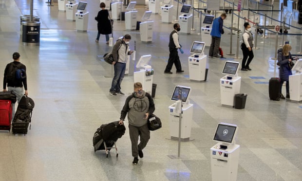 Travelers make their way through the Minneapolis-St. Paul international airport during the coronavirus pandemic.