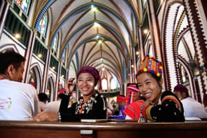 Catholics dressed in traditional ethnic attire gather for mass to be held by the pope at St Mary’s cathedral
