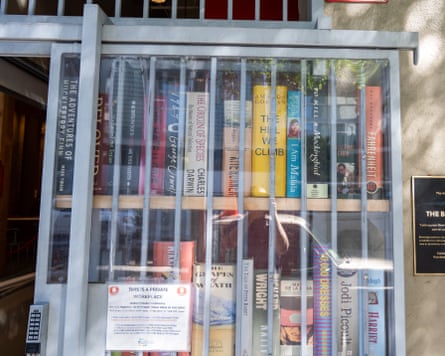 A display of banned books behind metal bars.