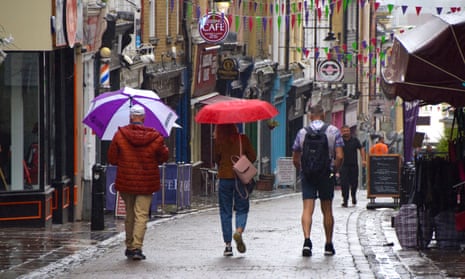 Shoppers with umbrellas in Gravesend, Kent