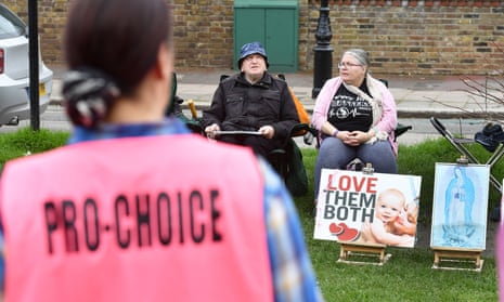 A pro-choice activist looks towards anti-abortion demonstrators outside the Marie Stopes clinic in Ealing, west London, in April. 