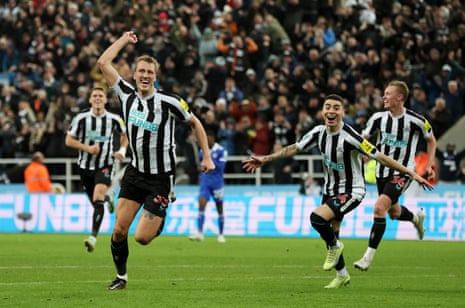 Newcastle United’s Dan Burn celebrates scoring their first goal with teammates, his first goal for the club.