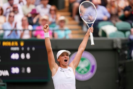 Iga Swiatek with arms aloft after winning her quarter-final at Wimbledon in 2025