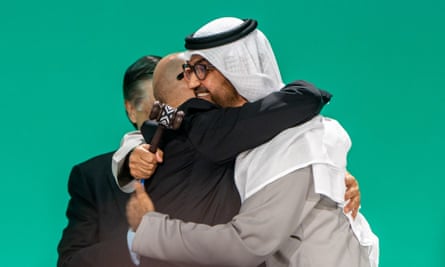 The Cop 28 president, Sultan Al Jaber, right hugs and UN climate chief, Simon Stiell, after a plenary session during the summit.