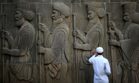 A man touches the wall of a Parsi fire temple featuring huge carvings of ancient priests on the occasion of the Persian New Year in Mumbai, India, March 21, 2019. REUTERS/Francis Mascarenhas