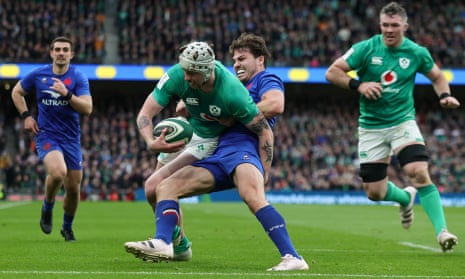 France’s Antoine Dupont tackles Ireland’s Mack Hansen on the line in Dublin during the highest quality Six Nations match in years.