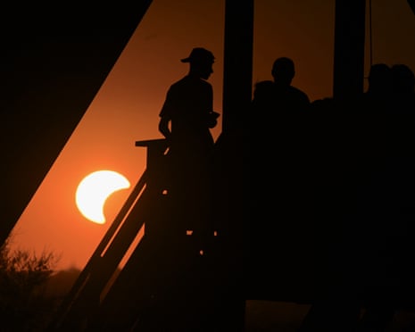 People gather at the Dinnyés Observation Tower to watch the partial solar eclipse close to Agard, Hungary.
