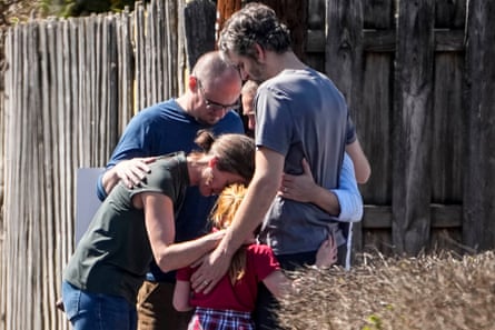 A group prays with a child outside the reunification center at the Woodmont Baptist church after a school shooting, in Nashville, Tennessee.