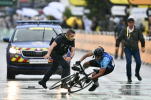 a man tackles a cyclist to the ground