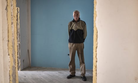 A man stands inside a damaged building in Chernihiv Oblast, Ukraine.