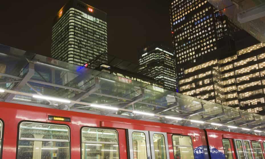A DLR train pulls in at Canary Wharf at night