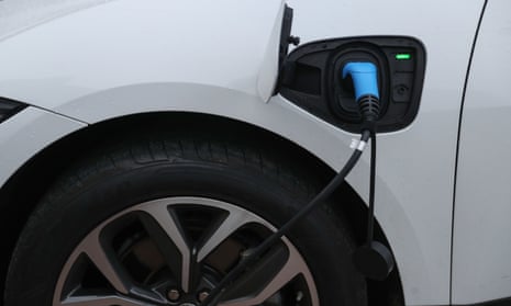 An electric charging cable connected to a Jaguar I-Pace.