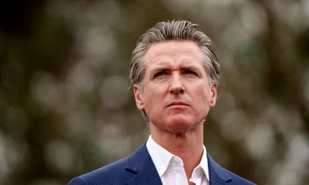 Man in suit looks ahead into camera