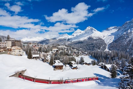 Rhaetian railway passing through snow in Arosa.