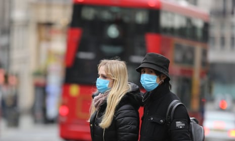 People in central London wear medical masks as a precaution against coronavirus.