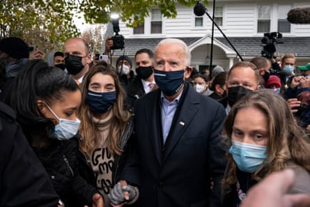 Biden walks with his granddaughter Natalie Biden as he visits a neighbour’s house after stopping at his childhood home.