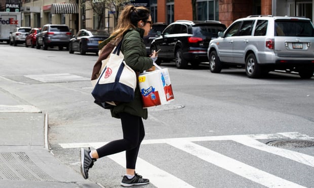 A woman carries groceries in New York, New York, on 22 March. 