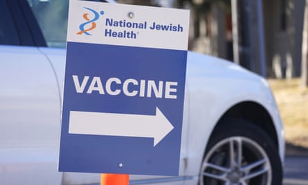 A sign directs motorist to a vaccination site at National Jewish Hospital on March 6, 2021, in east Denver