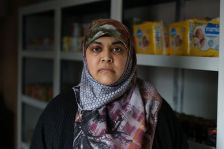 Sidrah Awan in front of shelves of nappies at a food bank