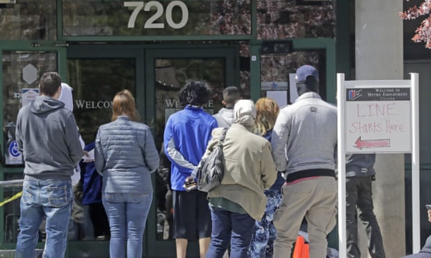 People line up outside the Metro Employment center in Salt Lake City. As unprecedented numbers of people apply for unemployment benefits, states are struggling to keep pace.