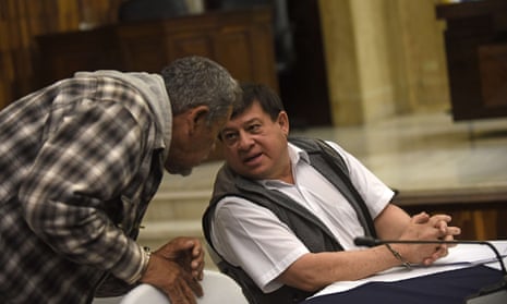 Former army officer Reyes (R) speaks with Valdez, a civilian who was attached to the Army, before listening to their sentence at a courtroom in Guatemala City.
