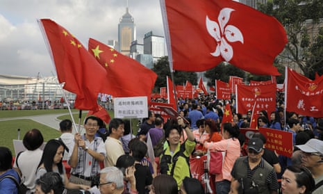 In Hong Kong thousands of pro-Beijing protesters raise Chinese and Hong Kong flags during a rally outside government headquarters on Sunday.