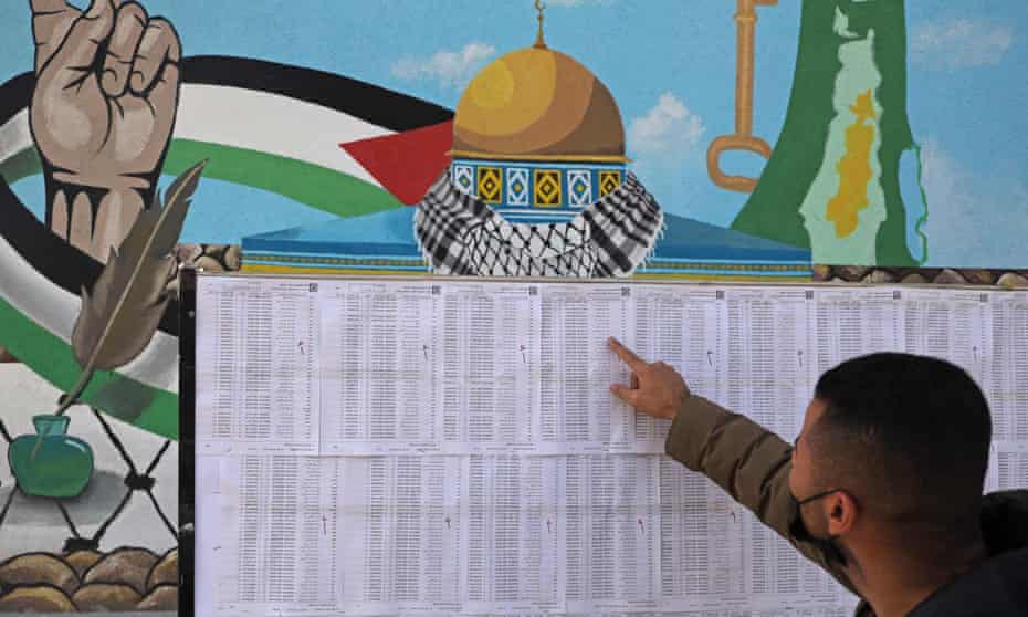 A Palestinian man looks for his name on the electoral roll, Gaza City, 3 March, 2021.